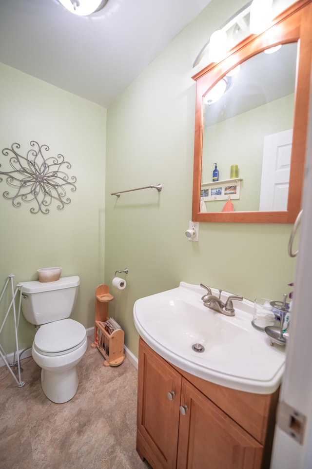 bathroom with tile patterned flooring, toilet, and vanity