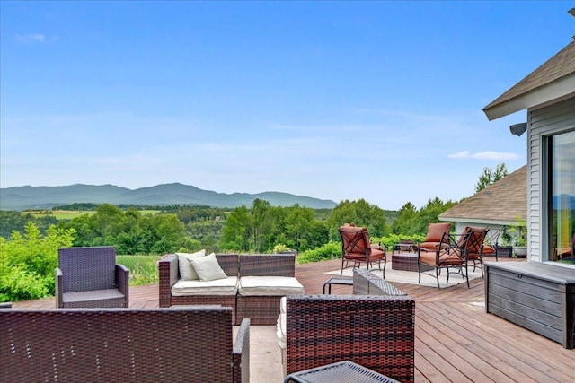 deck with an outdoor hangout area and a mountain view