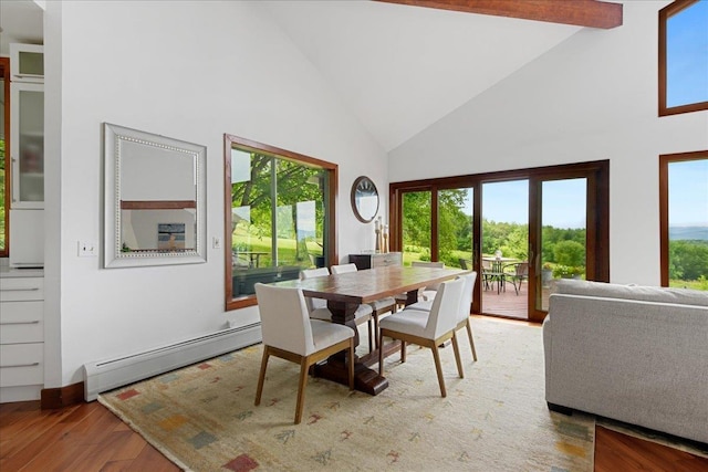 dining area featuring light hardwood / wood-style floors, high vaulted ceiling, and a baseboard heating unit