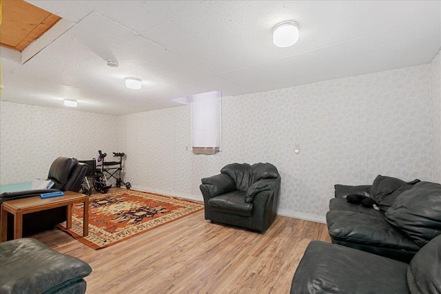 living room with light wood-type flooring and a textured ceiling