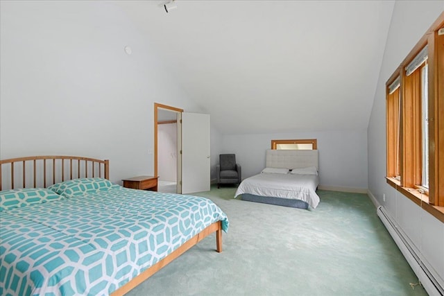 carpeted bedroom with a baseboard heating unit and vaulted ceiling