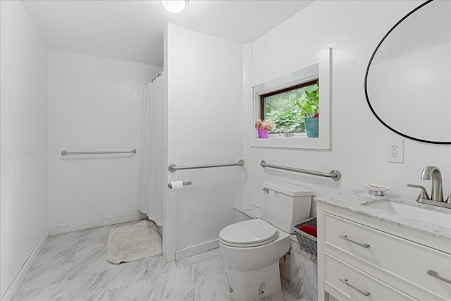 bathroom featuring toilet, vanity, and walk in shower