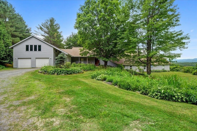 view of front of home with a front yard and a garage