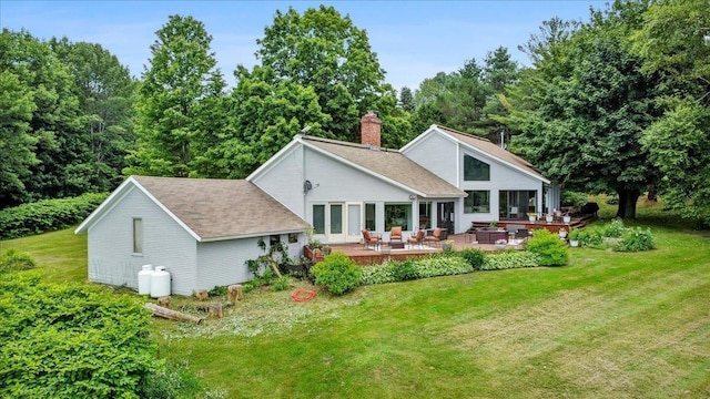 rear view of property featuring a yard, a deck, and an outdoor hangout area