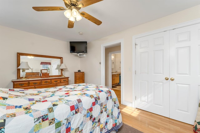 bedroom featuring light wood-style floors, a closet, and a ceiling fan