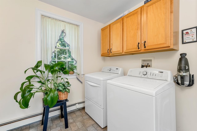 laundry area featuring cabinet space, stone finish floor, a baseboard heating unit, and independent washer and dryer