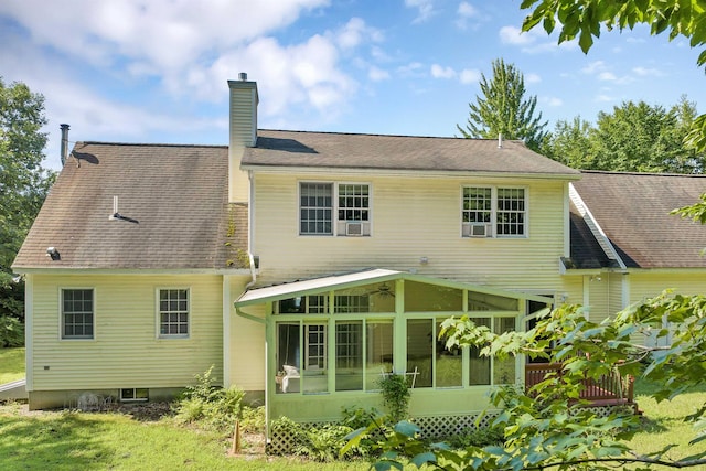 rear view of property featuring roof with shingles, a chimney, and a sunroom