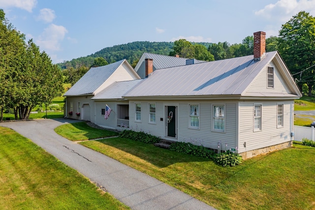 view of front of house with a garage and a front yard