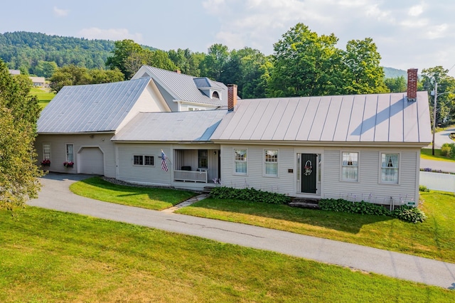 view of front of house with a garage and a front yard