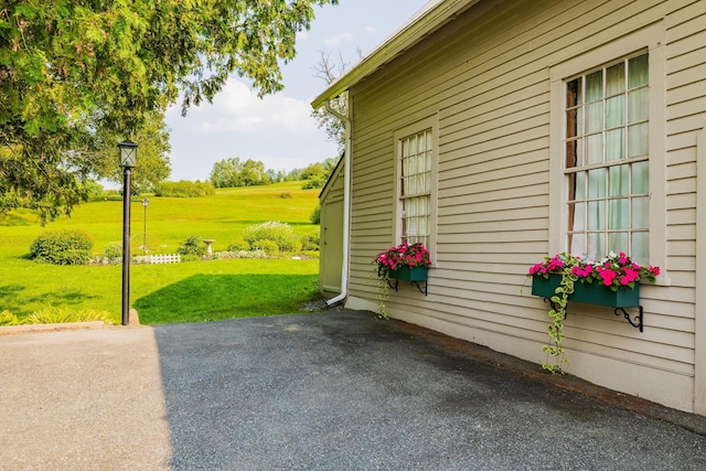 view of property exterior featuring a lawn