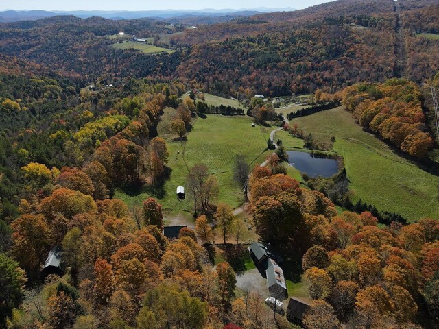 birds eye view of property featuring a view of trees