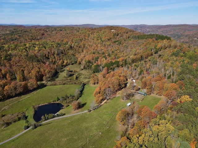 bird's eye view featuring a mountain view and a wooded view