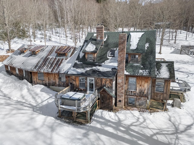 view of front of property featuring roof with shingles and a chimney