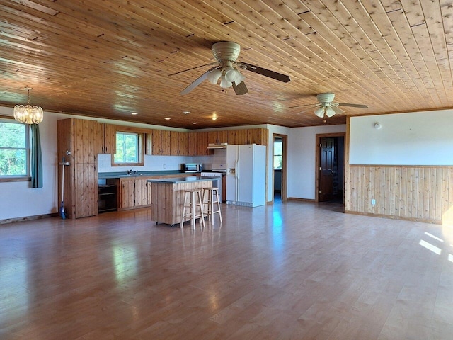 kitchen with white refrigerator with ice dispenser, wood-type flooring, range, and wood ceiling