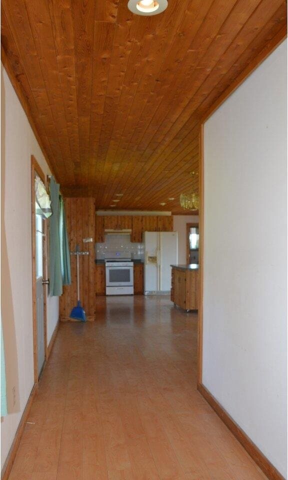 unfurnished living room with wooden ceiling