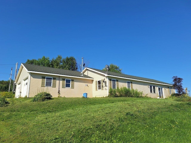 rear view of property featuring a yard