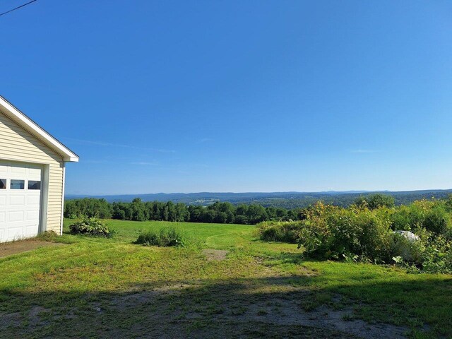 view of yard with a rural view