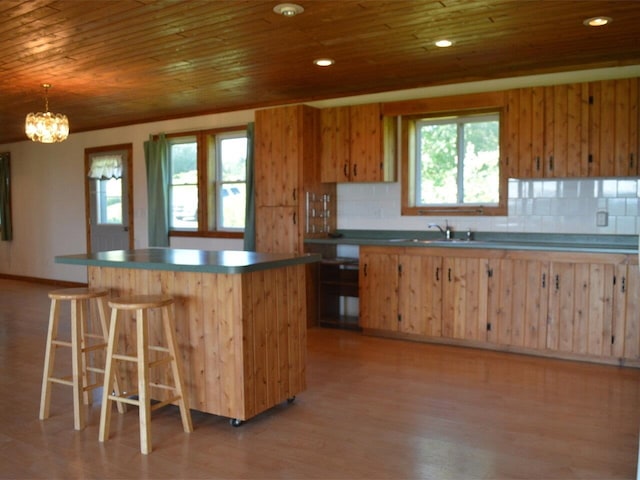 kitchen with tasteful backsplash, light hardwood / wood-style flooring, and wooden ceiling