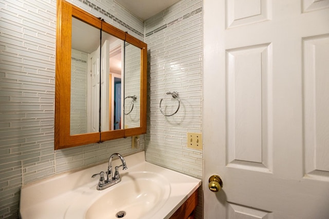 bathroom featuring tasteful backsplash and vanity