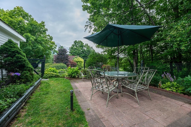view of patio with outdoor dining space and fence