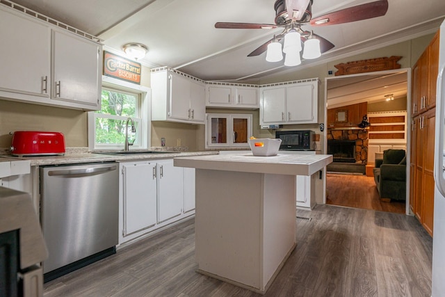 kitchen with white cabinetry, a sink, light countertops, black microwave, and stainless steel dishwasher