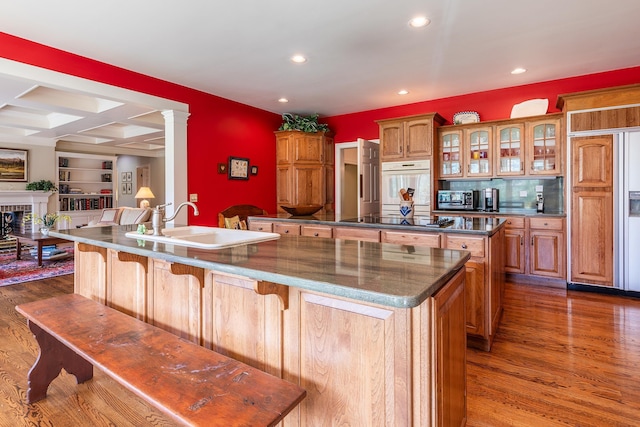 kitchen featuring black electric stovetop, a spacious island, and glass insert cabinets