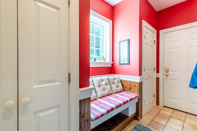 interior space with a wainscoted wall and light tile patterned floors