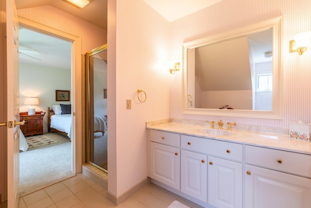 ensuite bathroom featuring a stall shower, connected bathroom, vanity, and tile patterned floors