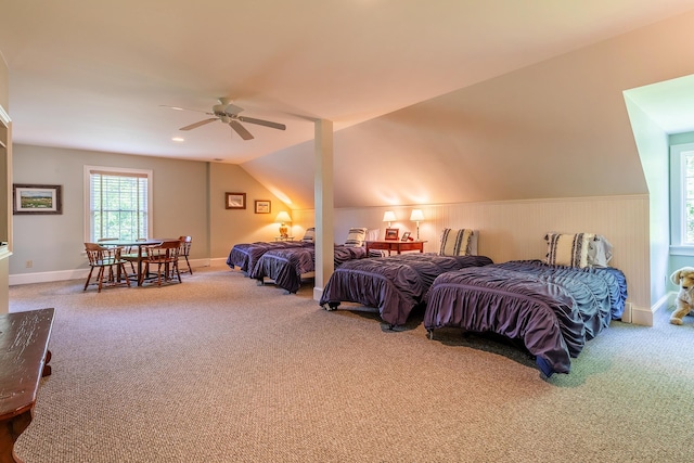 bedroom with carpet floors, a wainscoted wall, and a ceiling fan