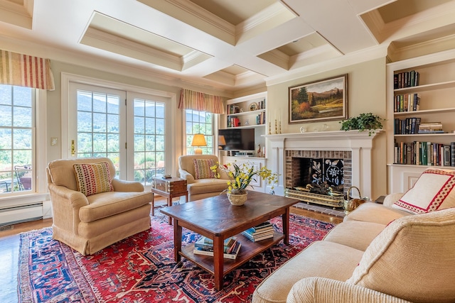 living area with coffered ceiling, ornamental molding, wood finished floors, baseboard heating, and beam ceiling