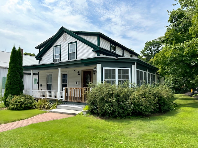 farmhouse-style home with covered porch and a front lawn