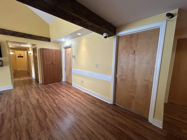 interior space featuring baseboards and wood finished floors