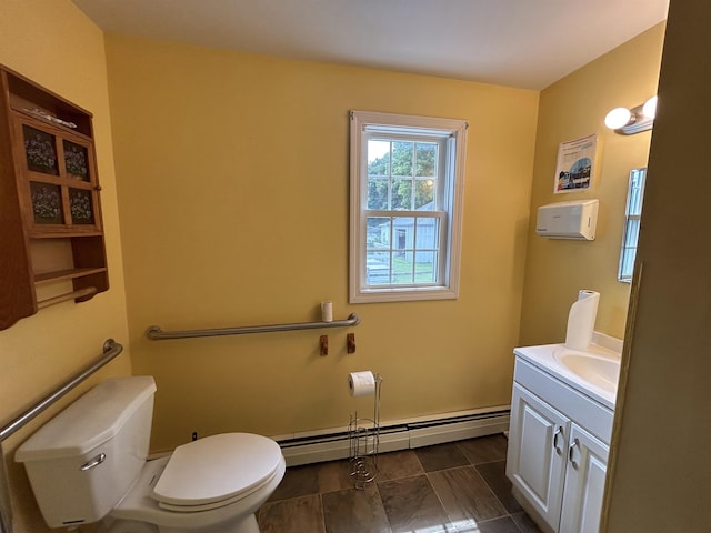 bathroom with baseboard heating, vanity, and toilet