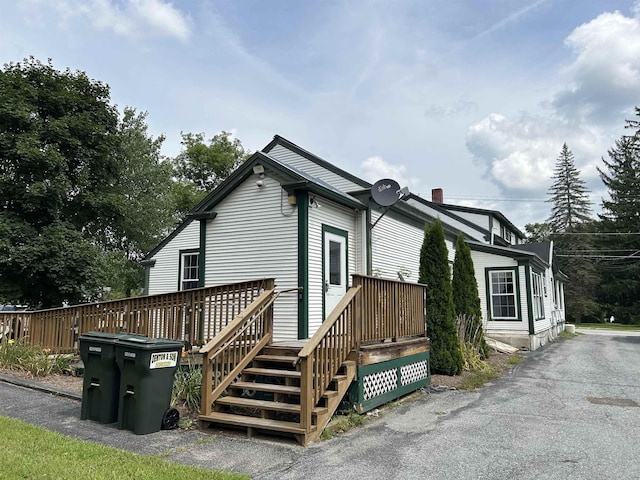 view of property exterior with a deck