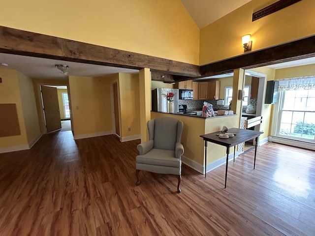 interior space with baseboards, beamed ceiling, dark wood-style floors, high vaulted ceiling, and a baseboard radiator