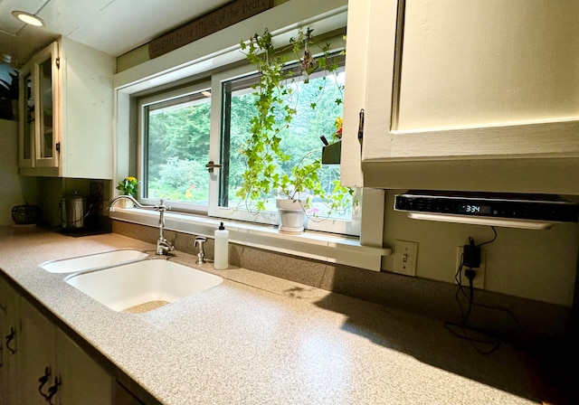 kitchen with sink and white cabinetry