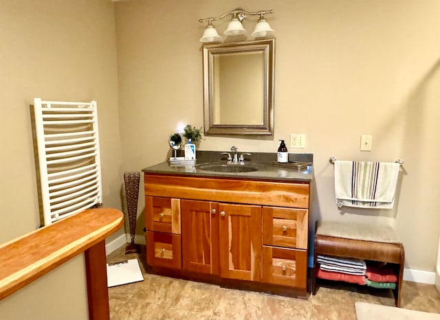 bathroom with radiator, vanity, and tile patterned floors