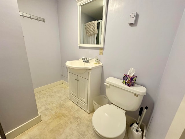 bathroom with vanity, tile patterned floors, and toilet