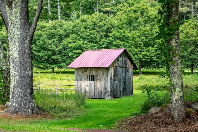 view of outbuilding featuring a yard