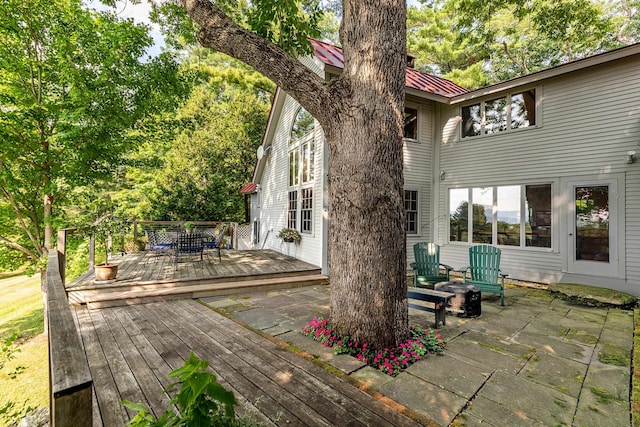 wooden terrace with a patio