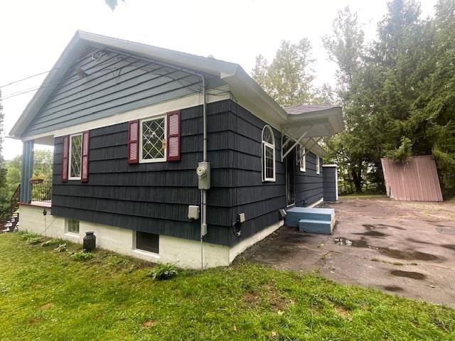 view of home's exterior with a lawn