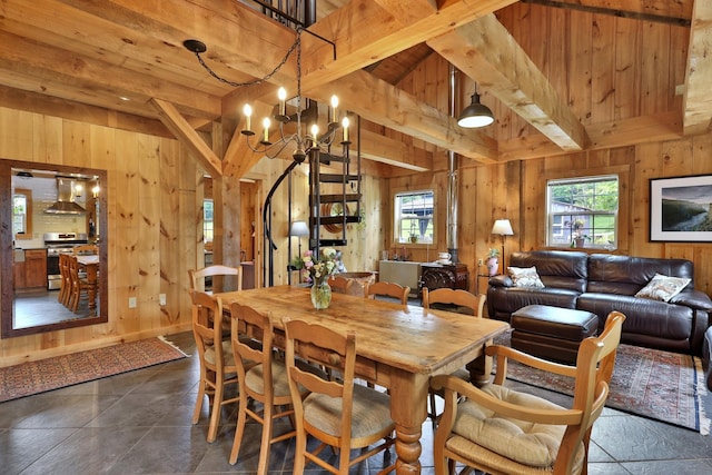 400 Ruusunen Rd, Springfield, VT 05156 - dining area featuring wooden walls, a notable chandelier, lofted ceiling with beams, and a healthy amount of sunlight