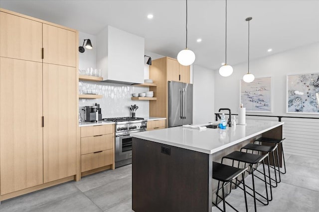 kitchen with a sink, light brown cabinets, a kitchen breakfast bar, high end appliances, and open shelves