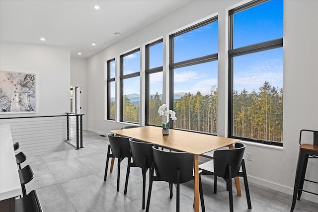 dining room with recessed lighting and baseboards