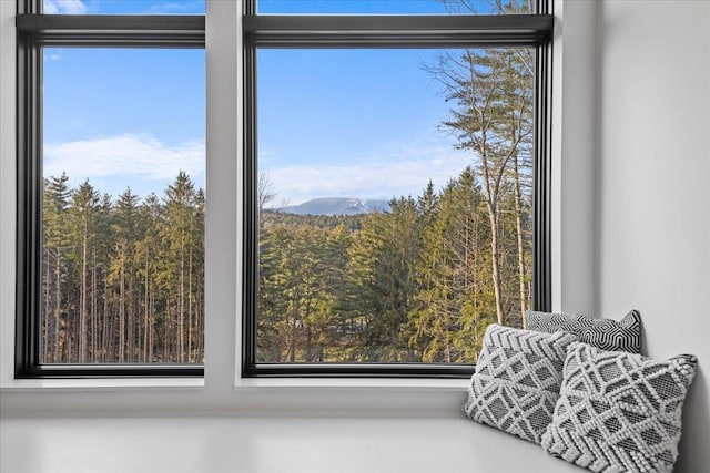 details featuring a mountain view and a view of trees