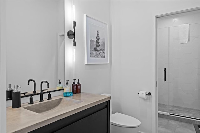 bathroom featuring vanity, toilet, and a stall shower