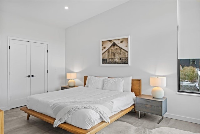 bedroom with a closet, recessed lighting, and baseboards