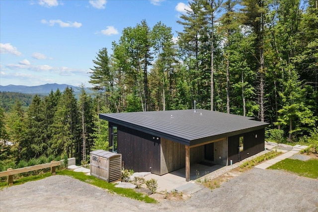 exterior space with a mountain view and a wooded view