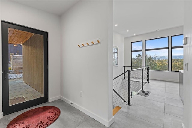 entryway with recessed lighting and baseboards