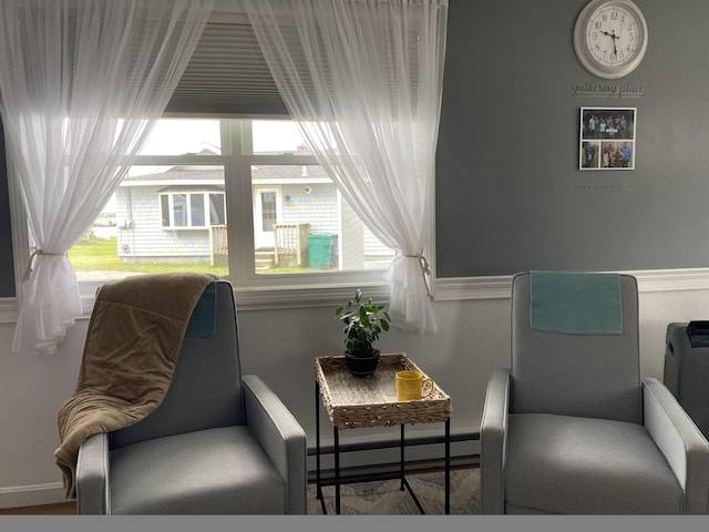 living area featuring a baseboard heating unit